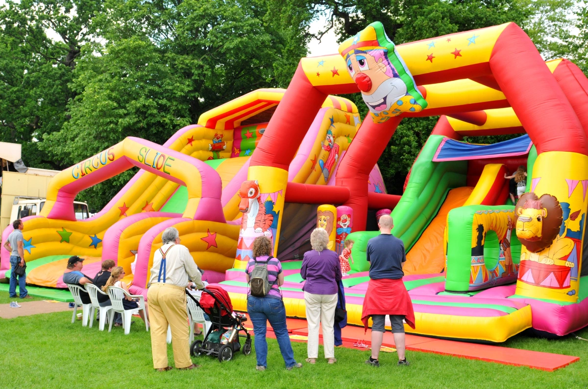 Children play in bouncing castle at amusement park 