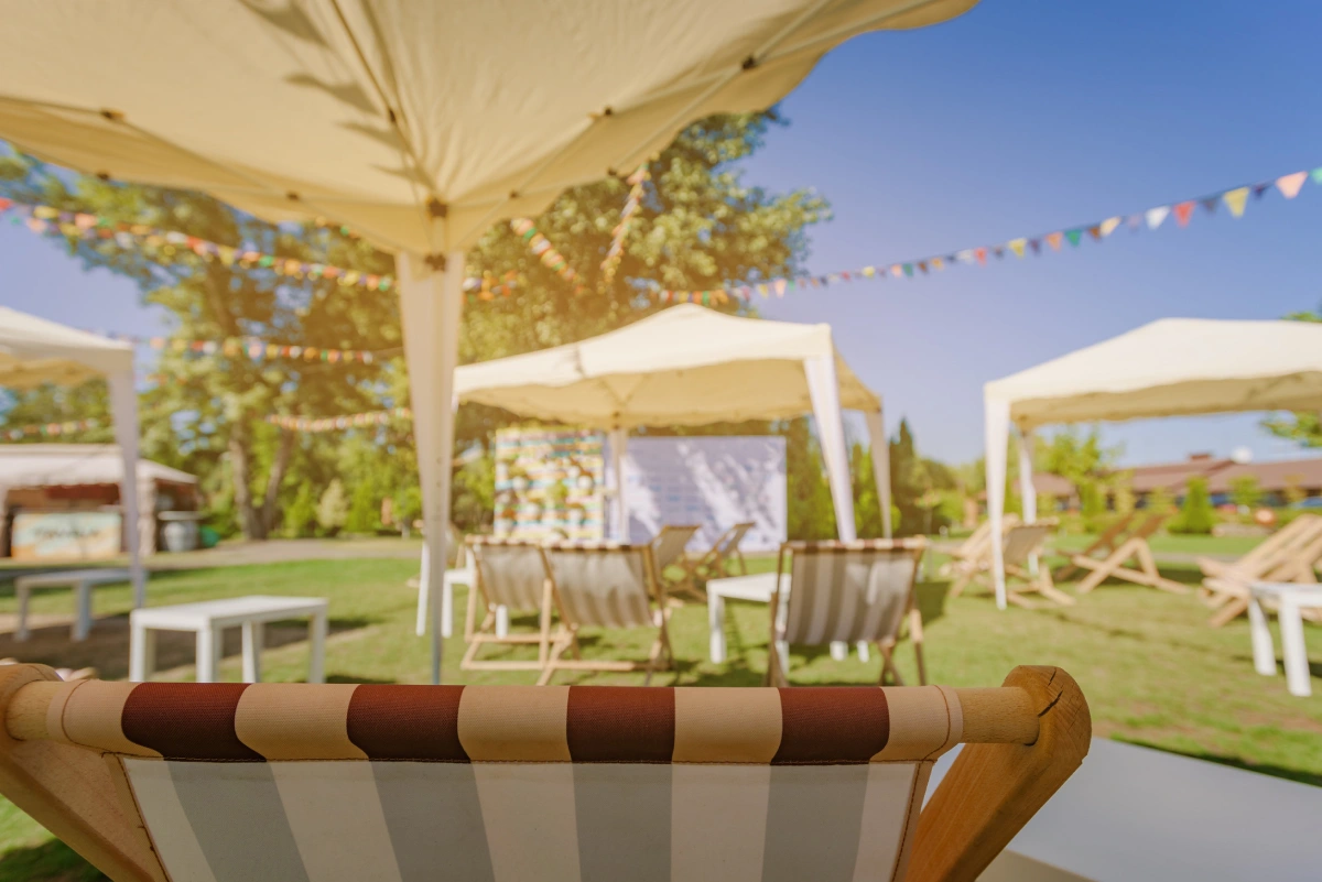 Furniture and decorated marquee for outdoor garden party on sunny summer day