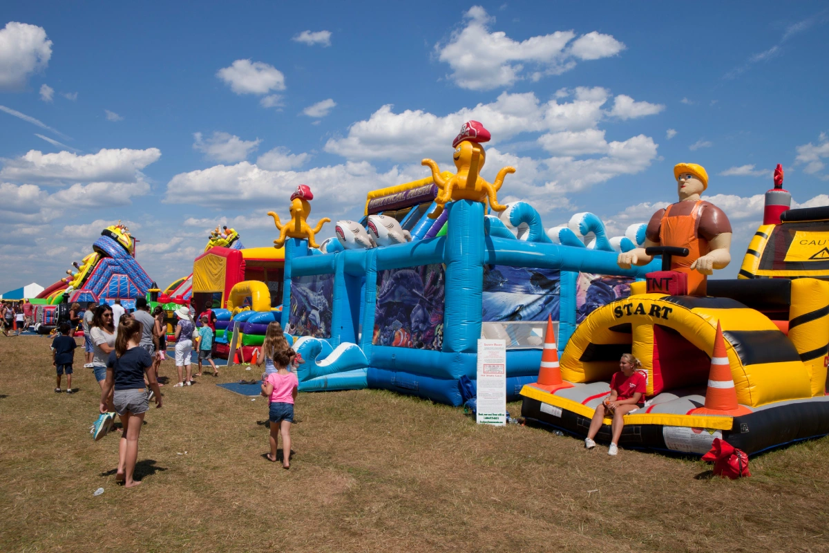 People enjoying some of the inflatable bounce houses, rides and activities at the New Jersey Ballooning Festival in Whitehouse Station, NJ